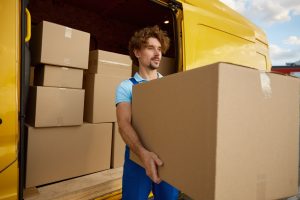 Male courier at work portrait, warehouse and store shipment goods service