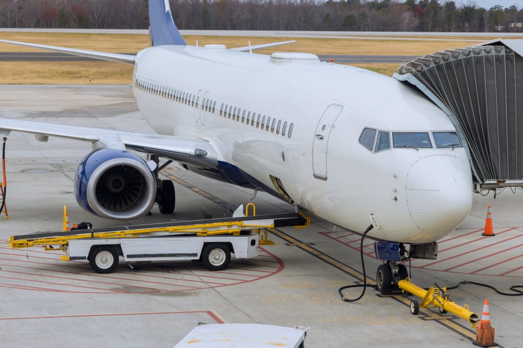 Preparation before flight with loading of cargo containers to airplane